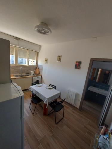 a kitchen with a table and chairs in a room at Bellavista Apartment in Cagliari