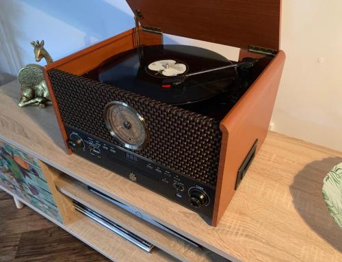 an old fashioned radio sitting on top of a table at Lower Flat, Nicolson House. in Portree