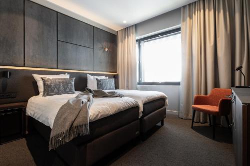 a bedroom with a large bed and a window at Lapland Hotels Arena in Tampere
