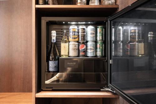 a drink cabinet with bottles of alcohol in it at Lapland Hotels Arena in Tampere