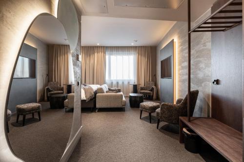 a hotel room with a bed and a mirror at Lapland Hotels Arena in Tampere