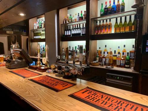 a bar with a lot of bottles of alcohol at Kestor Inn, Manaton, Dartmoor National Park, Newton Abbot, Devon in Manaton