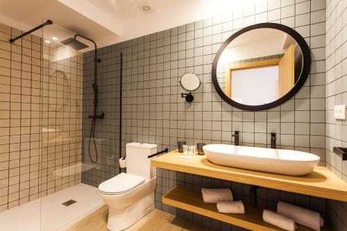 a bathroom with a sink and a mirror at Hospedium H Cabo Sport in Finisterre