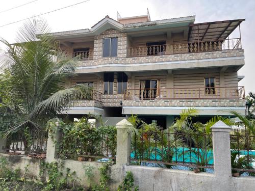a house with a pool in front of it at Neville's Villa - Pet friendly with Pool in Alibaug