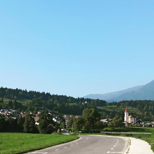 an empty road with a town and mountains in the background at Apartments Skok in Bled