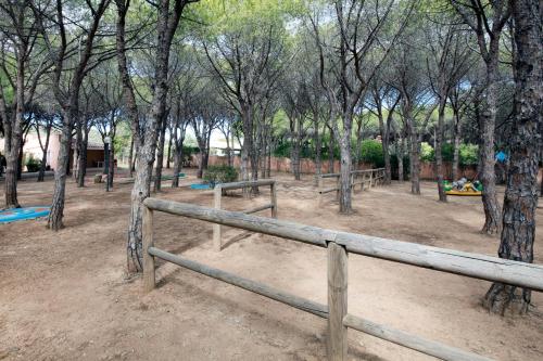 a park with a wooden fence and trees at Club Hotel Marina Seada Beach in Budoni