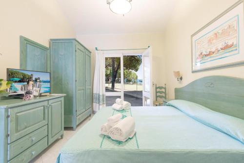 a bedroom with two beds with towels on them at Club Hotel Marina Seada Beach in Budoni