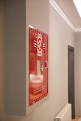 a sign on the wall of a bathroom at Sky Hotel Korce in Korçë