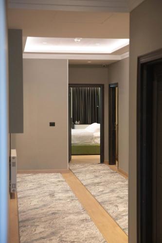 a room with a bedroom with a bed at Sky Hotel Korce in Korçë
