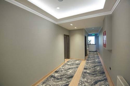 a hallway with a skylight and a ceiling at Sky Hotel Korce in Korçë