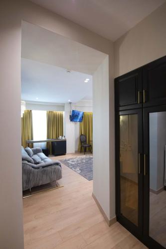 a living room with a bed and a couch at Sky Hotel Korce in Korçë