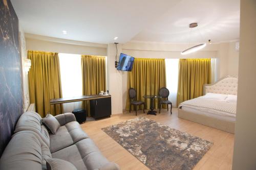 a living room with a couch and a bed at Sky Hotel Korce in Korçë