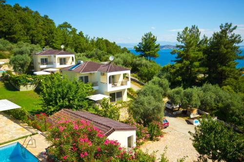 a house on a hill with a view of the water at Thassian Villas in Limenas
