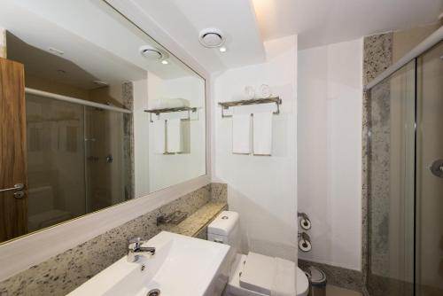 a bathroom with a sink and a mirror at Holiday Inn Natal, an IHG Hotel in Natal