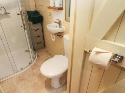 a small bathroom with a toilet and a sink at Fox in Keighley