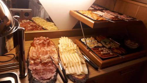 a bunch of different types of food on a counter at Hotel Garni Viktoria in Sankt Anton am Arlberg