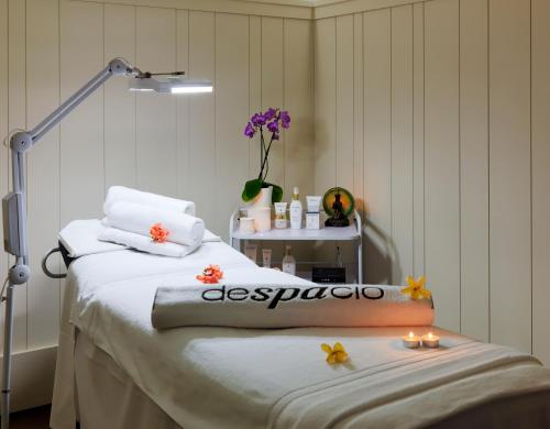 a bedroom with a bed with candles on it at Boutique Hotel H10 Big Sur - Adults Only in Los Cristianos
