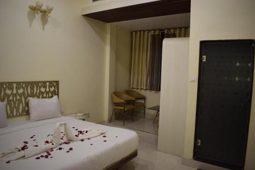 a hotel room with a bed with flowers on it at HOTEL THE HILLS in Ambikāpur