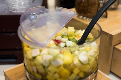 a blender filled with fruits and vegetables on a counter at Hotel de la Terrasse in Berck-sur-Mer