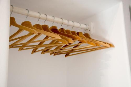 a bunch of wooden hangers hanging from a wall at Casa Di Volto in Skaládhos