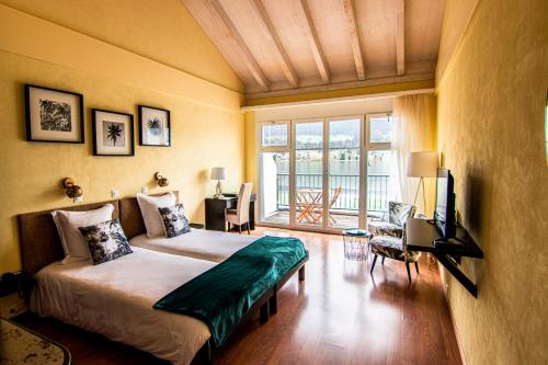 a bedroom with a bed and a television in a room at Bellevue le Rocheray in Le Sentier