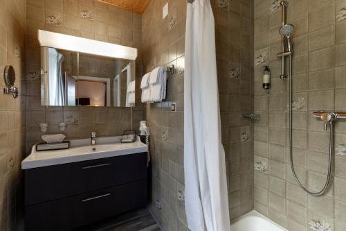 a bathroom with a shower and a sink and a tub at Bellevue le Rocheray in Le Sentier