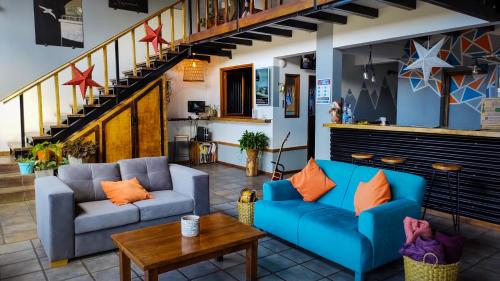 a living room with two blue couches and a table at Antarctica Hostel in Ushuaia