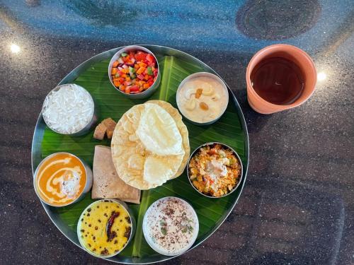 a plate of food on top of a banana leaf at Veda5 Ayurveda Living Village in Trichūr