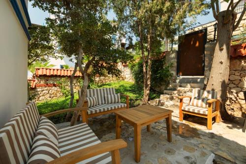 a patio with chairs and a table and a table and chairs at Soothe Hotel in Kalkan