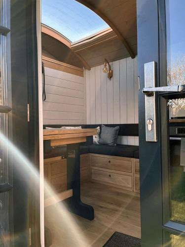 a sauna with a table and a bench in a room at Cocklebury Farm in Pewsey