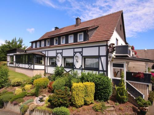a house with a garden in front of it at Gasthof "Zum Burghof" in Medebach