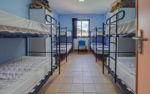 a room with three bunk beds and a hallway at Camping Alberg Municipal Tivissa in Tivissa