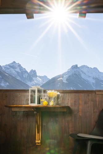 a table with a blender on a fence with mountains at KASSNHOF - Urlaub in den Bergen in Telfes im Stubai