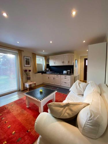 un soggiorno con un divano bianco e un tavolo di App 3 a List