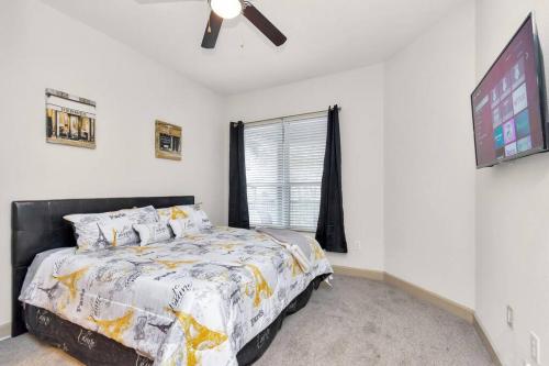 a bedroom with a bed and a flat screen tv at Stylish Open Concept Apt with King Bed, walking distance from NRG Texans Stadium, 1 mile to Med Center, Free Parking in Houston