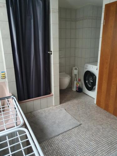 a bathroom with a toilet and a shower with a shower curtain at Ferienwohnung Nina direkt in Zentrum in Bad Wildbad