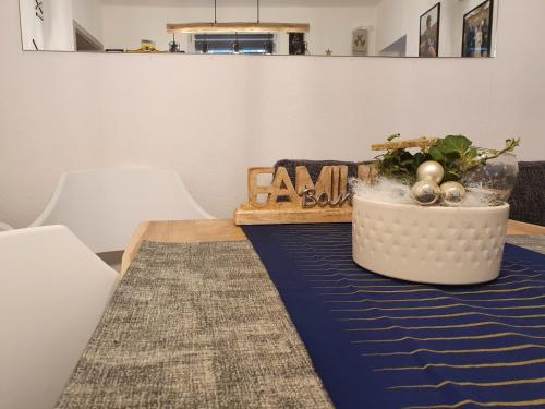 a table with a blue table cloth and a plant on it at Ferienwohnung Nina direkt in Zentrum in Bad Wildbad