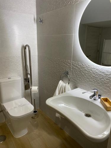 a bathroom with a sink and a toilet and a mirror at SIERRA NORTE-TERVILOR in Canencia