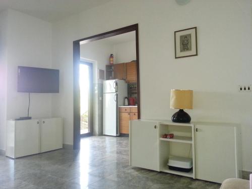 a living room with a refrigerator and a mirror at 230 MESTRO in Stanići
