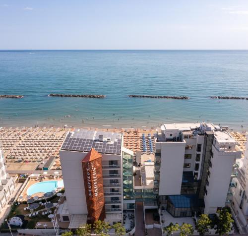 a view of a beach and buildings and the ocean at Nautilus Family Hotel in Pesaro