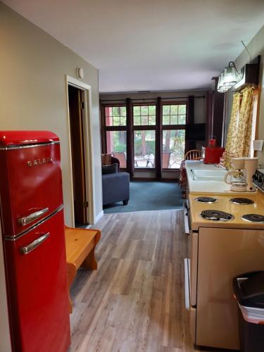 a kitchen with a red refrigerator next to a sink at Swiftcurrent Lodge in Estes Park