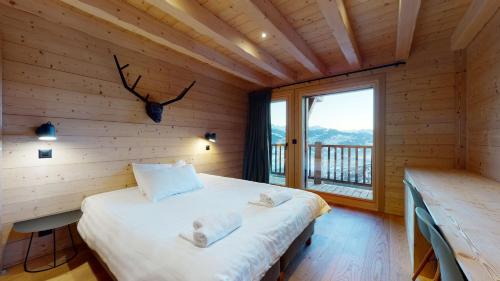 1 dormitorio con 1 cama en una habitación de madera con ventana en Dream COSY & QUIET chalet 9 pers, en Arbaz