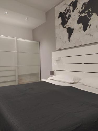 a bedroom with a bed with a map on the wall at Helvetia Garibaldi in Genoa