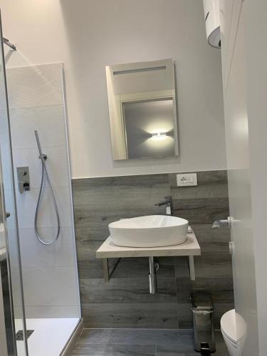 a bathroom with a sink and a mirror at Helvetia Garibaldi in Genoa