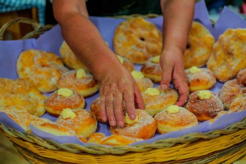 a person with their hands on a basket of donuts at L'Oasi del Cervo in Arbus