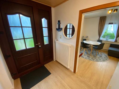 a hallway with a door and a table in a room at Haus Sternenstrand Tossens in Butjadingen OT Tossens
