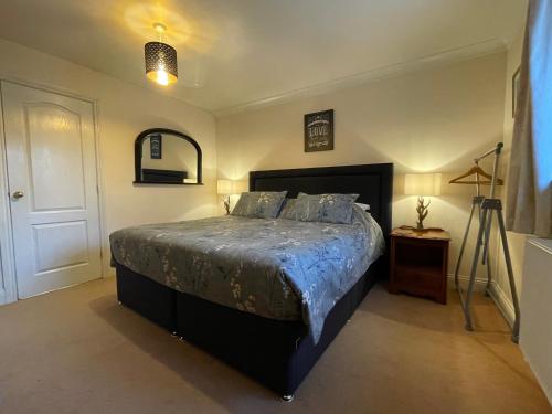 a bedroom with a large bed and a camera at Graceland Farm B&B in Brockenhurst
