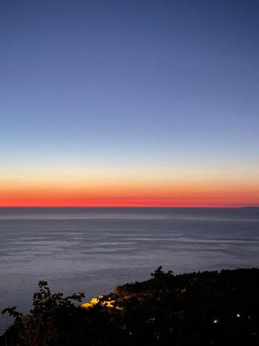 a view of the ocean at sunset at Villa Skyfall in Kalamitsi