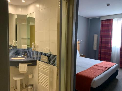 a hotel room with a bathroom with a bed and a sink at Bes Hotel Bergamo Ovest in Mozzo