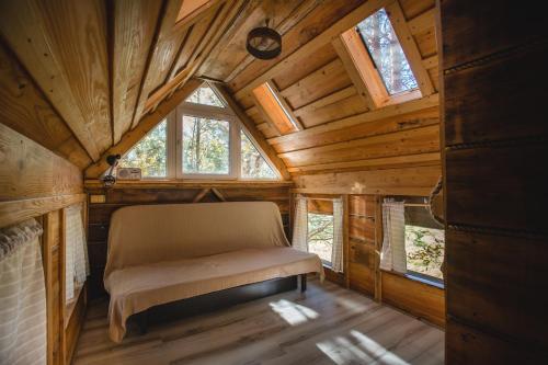 a bedroom in a tree house with a bed in it at Sokolskie Chaty in Gorlice